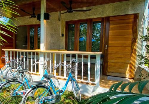 two bikes parked on the porch of a house at Malai Maikhao Near Beach in Ban Mai Salae