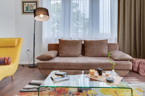 a living room with a couch and a glass table at Apartment Jadera in Zadar