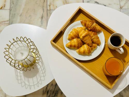 a plate of croissants and a cup of coffee at Venetian Gem Central Corfu Retreat in Kanoni