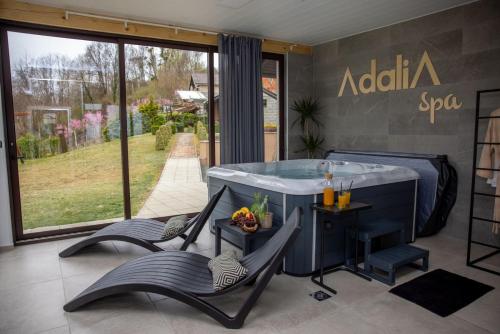 a spa with two chairs and a tub in a room at Holiday Home AdaliA in Štrigova