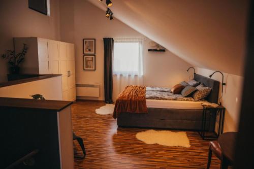 a bedroom with a bed and a staircase with a window at Holiday Home AdaliA in Štrigova