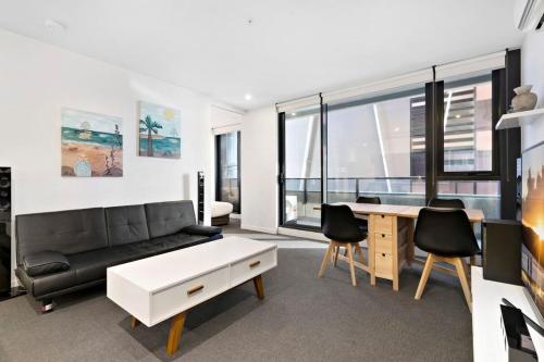 a living room with a couch and a table at 'Santeri' A Simple Stay with Modern Facilities in Melbourne