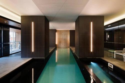 a swimming pool in the middle of a building at 'Santeri' A Simple Stay with Modern Facilities in Melbourne