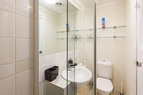 uma casa de banho com um lavatório, um WC e um chuveiro em 'Ann Student Studio' Queen Pad on Lygon Street em Melbourne
