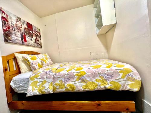 a small bedroom with a bed with a colorful comforter at Tiny Private Room at the Upper Level of a Big House with Shared Bathroom in Seattle