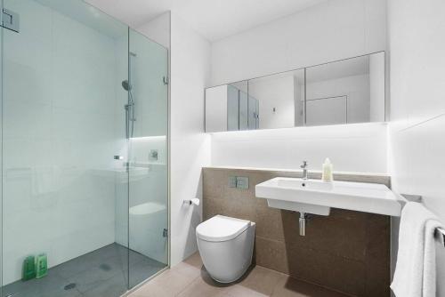een badkamer met een toilet, een wastafel en een douche bij CBD Serenity with Luxury Rooftop Pool and Parking in Melbourne
