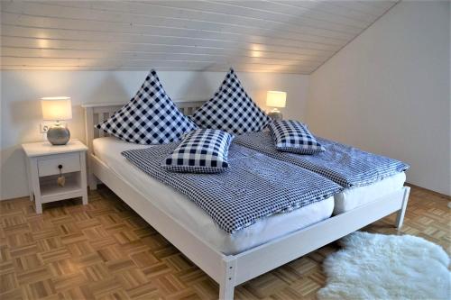a bedroom with a bed with blue and white pillows at Ferienhaus Heck in Obernheim