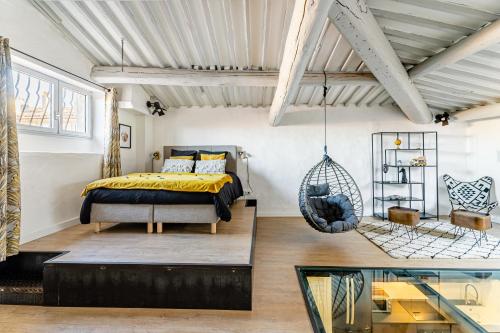 馬賽的住宿－Loft ravissant Vieux Port Marseille, Clim，一间卧室配有一张床和一个悬挂秋千