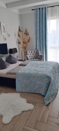 um quarto com uma cama com um cobertor azul em Apartament Blue Sky em Lubin