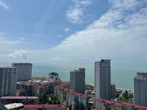 a view of a city with tall buildings and the ocean at Pirosmani Mini Hotel in Batumi