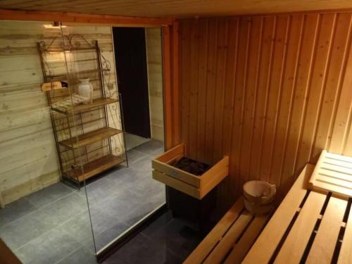 a sauna with a stove and a shelf in it at Odalys Chalet Le Chabichou in Les Deux Alpes