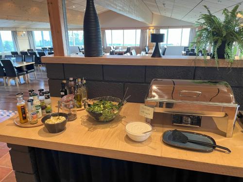 a counter with a buffet with food on it at Hotel Natur Akureyri in Akureyri