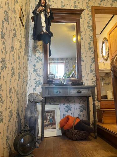 a woman is sitting on a dresser in front of a mirror at Schönbachhof in Silz