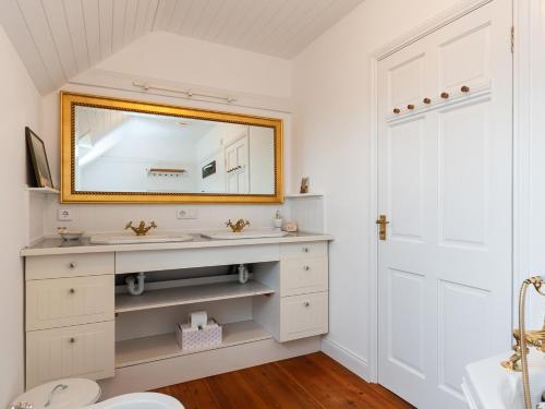 a bathroom with a sink and a mirror at The Schooner in Goleen