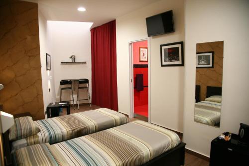 a hotel room with a bed and a mirror at Duomo Bed & Breakfast in Catania