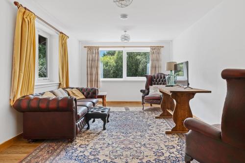 a living room with a couch and chairs and a table at Finest Retreats - The Logs in Fort William