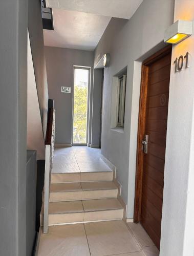 a hallway with stairs leading to a door at Atlantic Affair Boutique Hotel in Cape Town