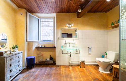 a bathroom with a toilet and a sink in it at La maison du Bonheur in Marquixanes