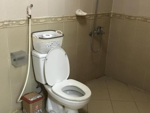 a small bathroom with a toilet and a shower at 105 Láng Hạ in Hanoi