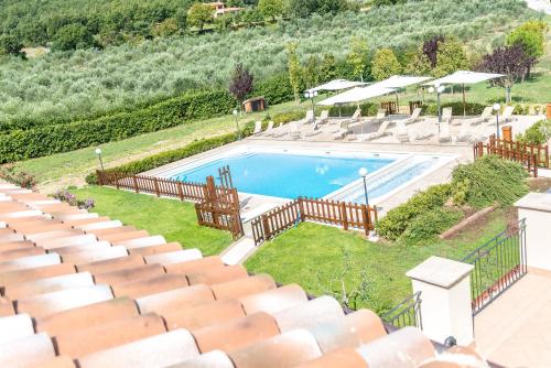 a swimming pool with a lot of seats in a stadium at Relais Paradiso Resort & Spa in Gualdo Cattaneo