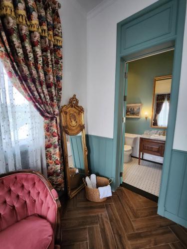 a living room with a couch and a mirror at La Campagne Villa Chiangmai in Chiang Mai