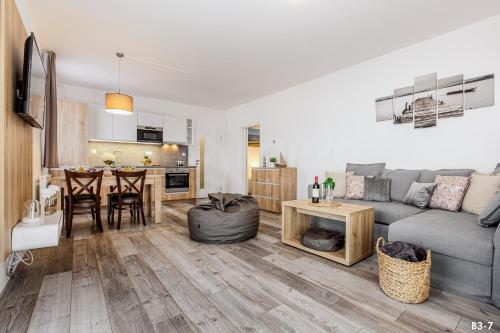 a living room with a couch and a table at KORZO Lipno in Lipno nad Vltavou