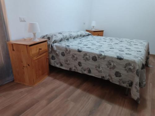 a bedroom with a bed and a night stand with a lamp at Cottage OstiaAntica in Ostia Antica