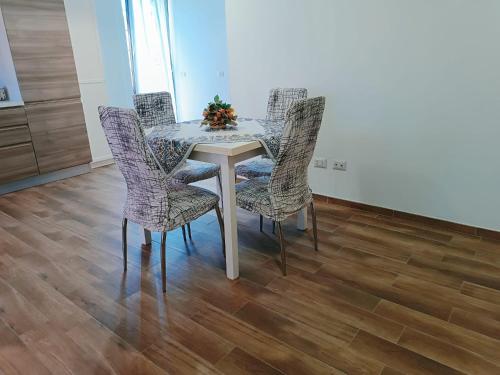 a dining room table and chairs with a christmas tree on it at Cottage OstiaAntica in Ostia Antica