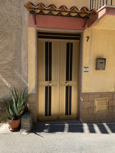 a door to a building with a potted plant in front at Casa Fontanelle in Burgio