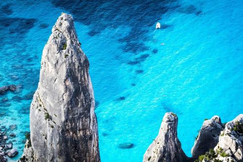 a group of rocks in the water at ISA-Residence with swimming-pool in Tanaunella, apartments with air conditioning and private outdoor space in Tanaunella