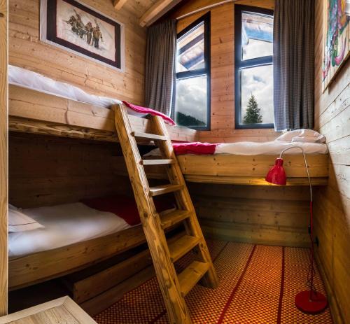 une chambre avec deux lits superposés et une échelle dans l'établissement Igloo, à Morzine