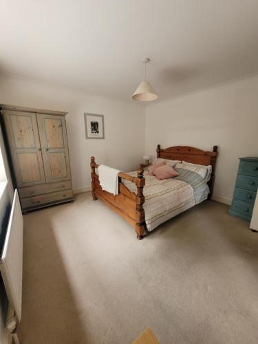 1 dormitorio con cama de madera y puerta en Lovely 2 Double Bed Aptmnt in Historic Greenwich en Londres