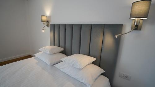 two pillows sitting on a bed in a room at Pensiunea Magic in Băile Govora