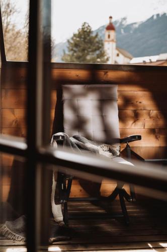 a view from a window of a bench on a porch at Schönherr Haus in Neustift im Stubaital