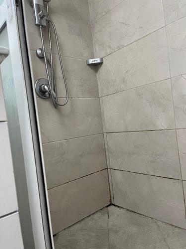 a shower with a glass door in a bathroom at Skyline Serene Stay in Tel Aviv
