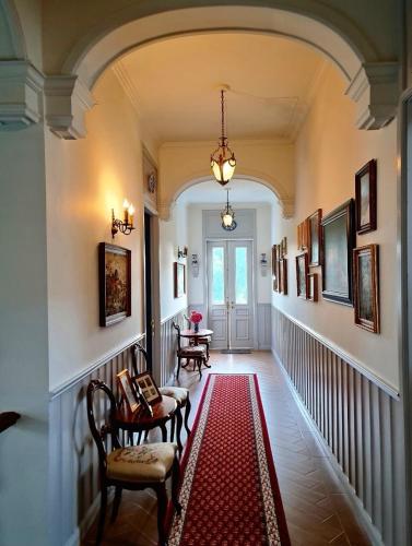 a hallway with chairs and a red rug at La Campagne Villa Chiangmai in Chiang Mai