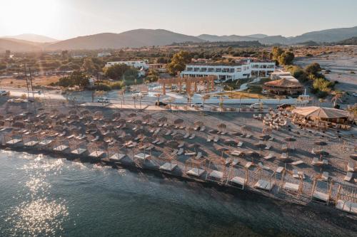an aerial view of a beach with umbrellas and the water at Alia Luxury Beachfront Suites and SPA in Haraki