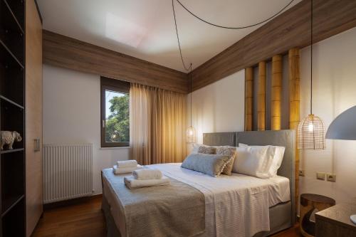 a bedroom with a large bed with towels on it at JW luxury apartment in Chania