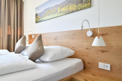 a bedroom with two beds with white pillows at Guest House Vračko in Zgornja Kungota