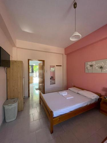 a bedroom with a large bed in a room at Yfantis Sakis Apartment's in Erateini