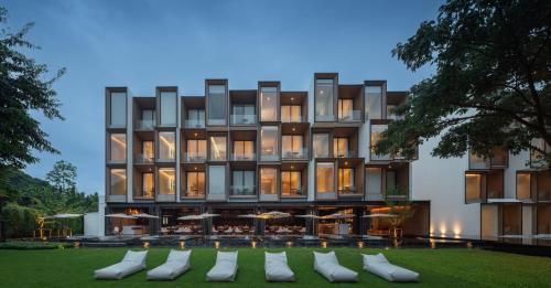 a rendering of a building with chairs in front of it at Riva Vista Riverfront Resort Chiang Rai in Ban Fang Min