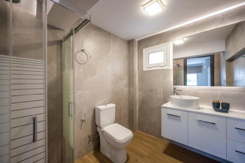 a bathroom with a toilet and a sink and a shower at YoZa Villa in Kokkíni Khánion