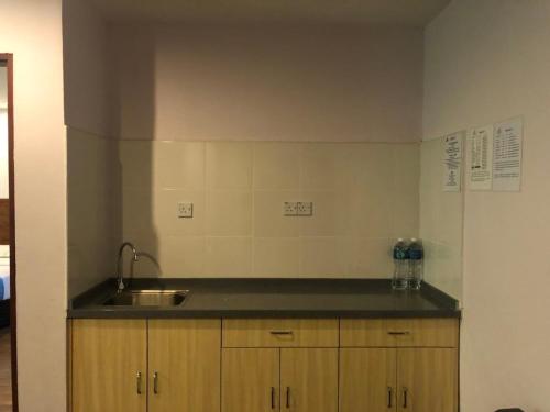 a kitchen with a sink and a counter top at TD Mutiara Hotel Semporna in Semporna