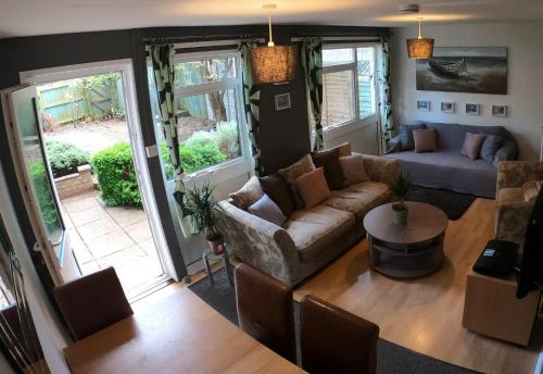 a living room with a couch and a table at Hampton House Book-Inn in Northampton