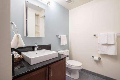 a white bathroom with a sink and a toilet at Loop 1BR w Gym Pool nr Financial District CHI-232 in Chicago