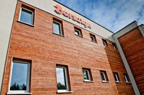 a brick building with a sign on the side of it at Ośrodek Wczasowy Bursztyn in Gdańsk