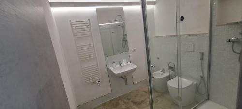 a bathroom with a sink and a toilet and a shower at La Commenda di Picciano - Country House in Matera