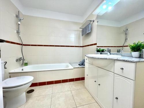 a bathroom with a tub and a toilet and a sink at One bedroom apartment ZEN with great view, pool, WiFi in Chayofa