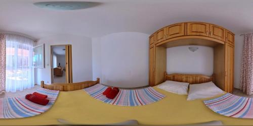 a bedroom with a large bed with a wooden headboard at Krk Kornic Apartments in Kornić