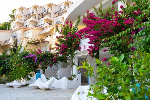 a building with pink flowers in front of it at Bougainville Bay Apartments in Sarandë